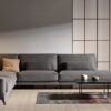 sofa rinconera tapizado en tela gris con patas